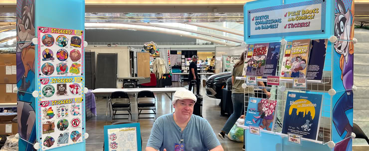Artist at his table at Anthrocon '25