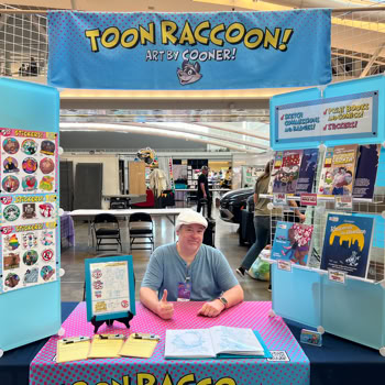 Artist at his table at Anthrocon '25